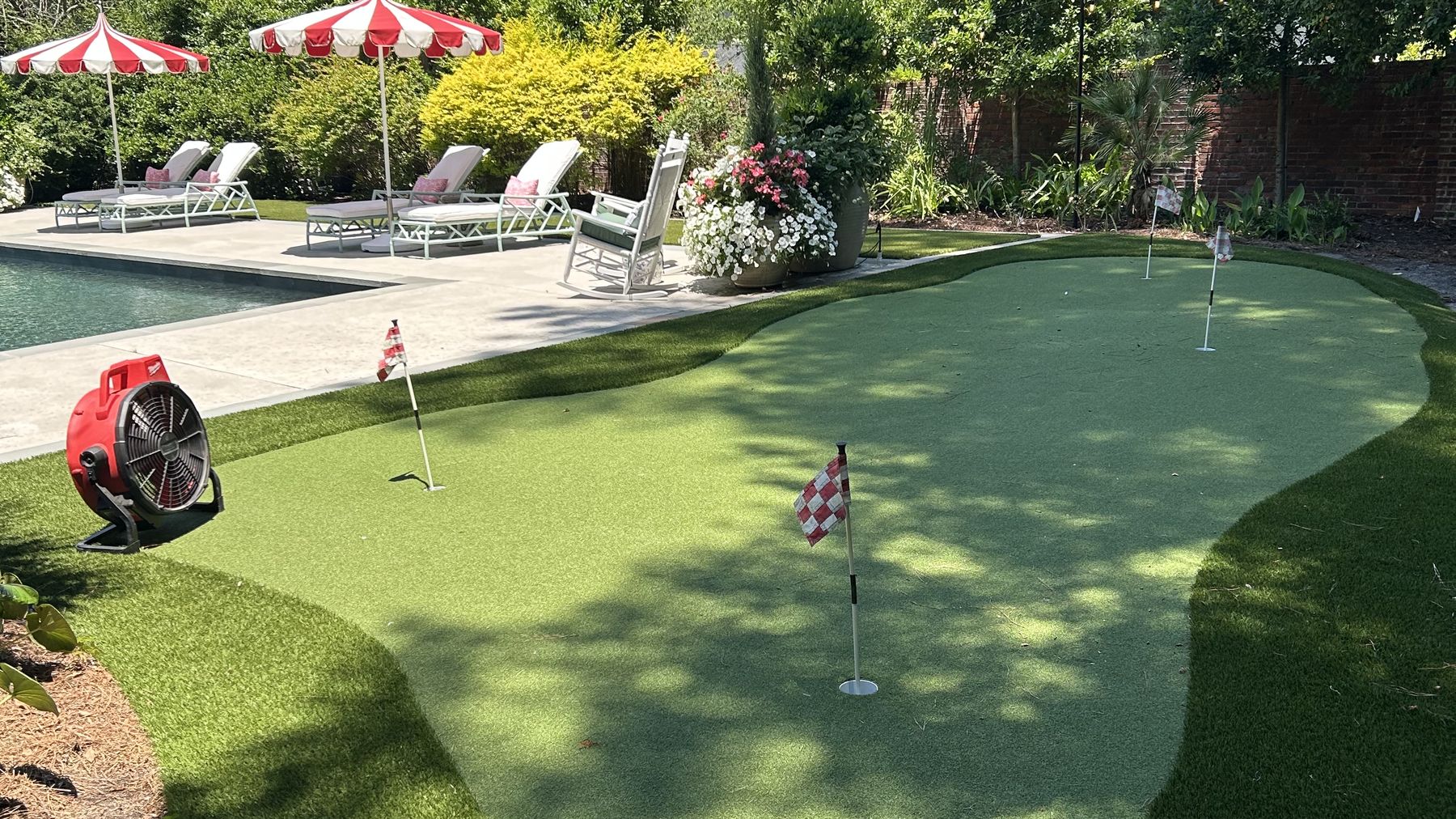 Intact putting green and pool deck above a sewer line repaired by trenchless pipe lining